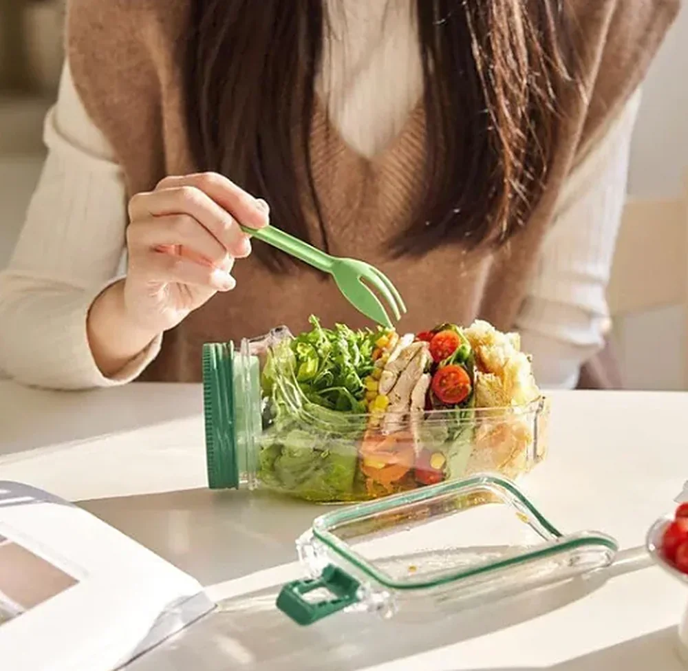 Side-open salad jar at a work desk with the dressing kept in its separate sealed cup